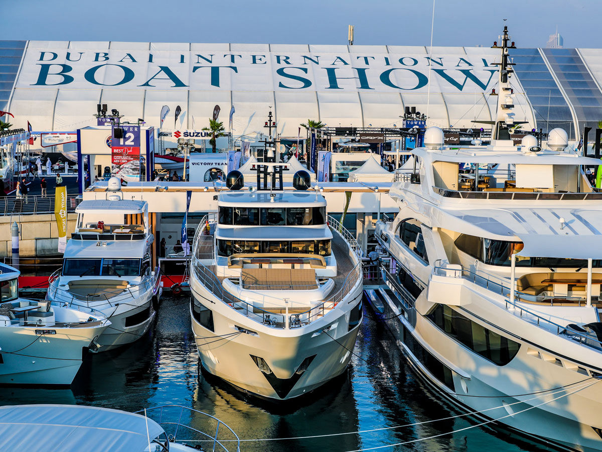Aerial view of the Dubai International Boat Show at Dubai Harbour, showcasing luxury yachts and the Dubai skyline.